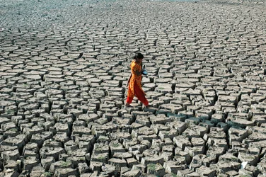 A Young Girl and Her Sister from the Below Poverty Level Group, at the Dried Up River Bed of Buriganga, in Hazaribagh, Dhaka, Bangladesh. March 4, 2005.